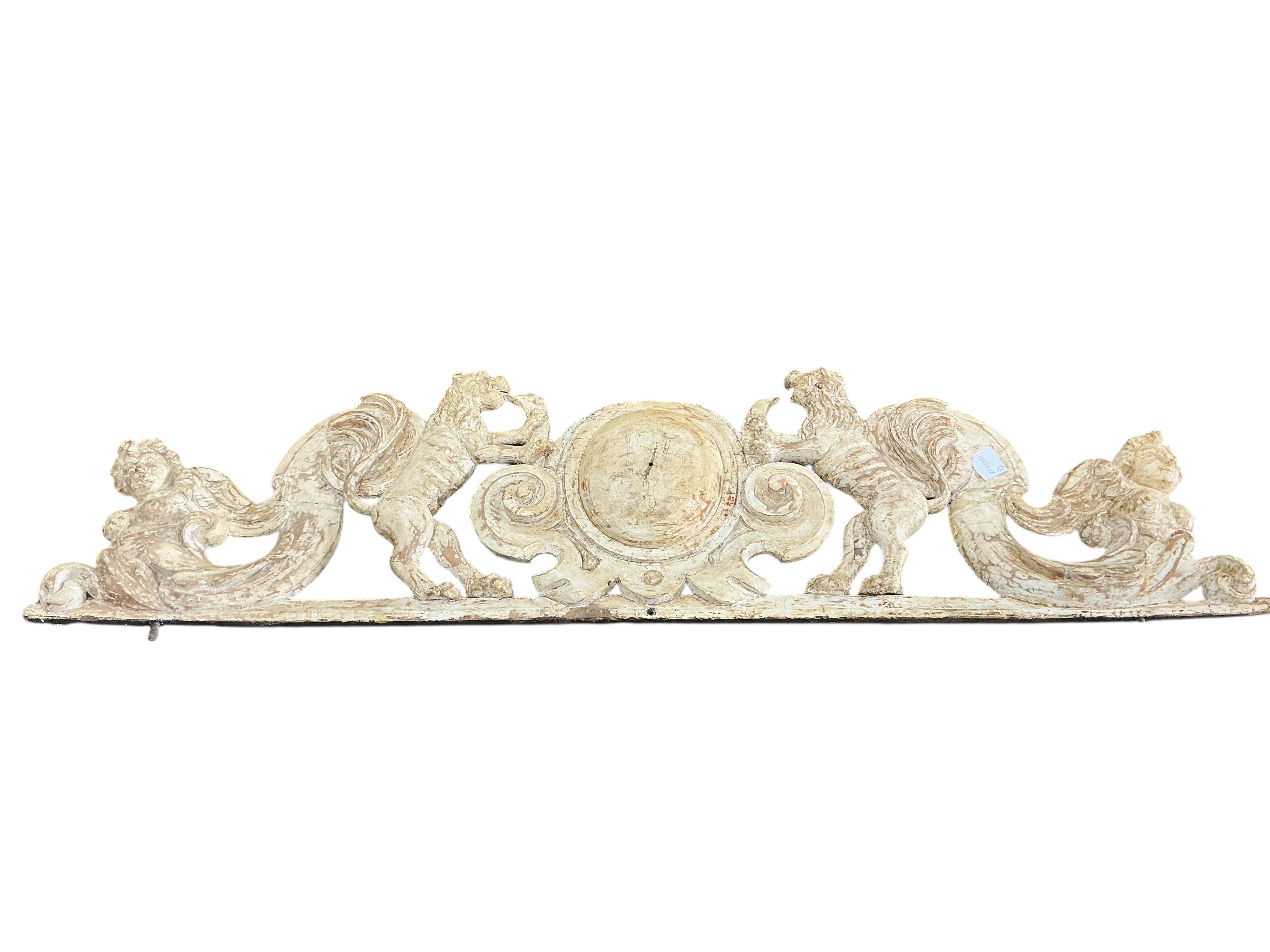 Two cream painted carved wood pediments, largest width 132cm
